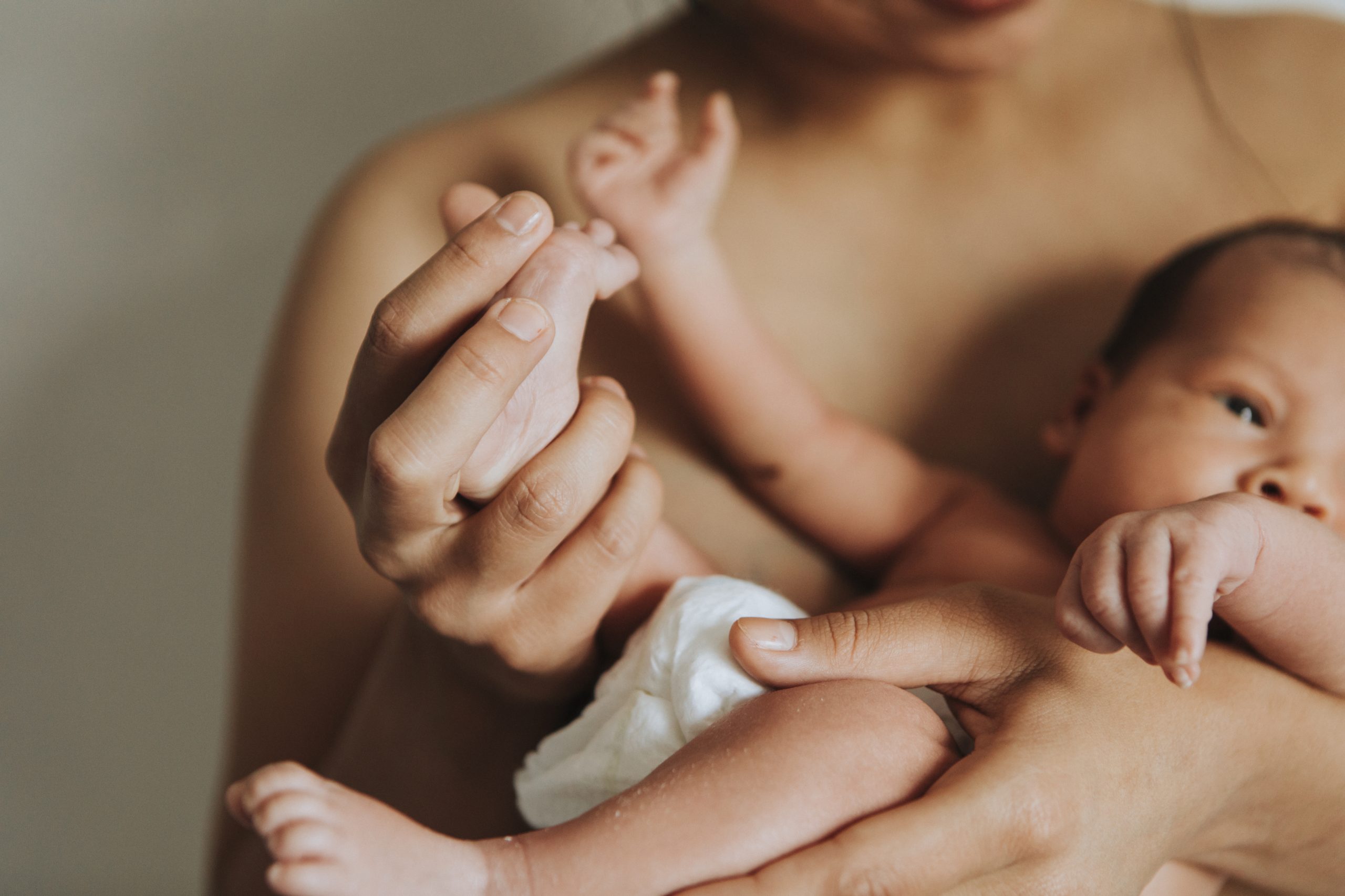 mother holding her infant baby scaled